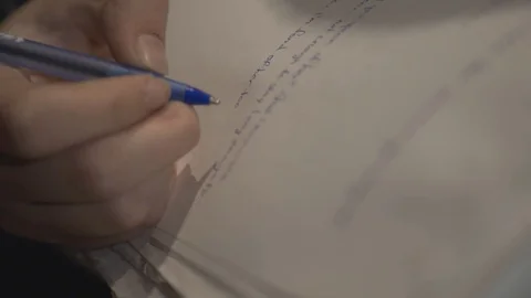 A Person Continue Writing In A Paper Using Blue Ballpen - Closeup Shot Video stock 128144774