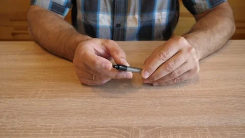 A person continuously presses the push button of a ballpoint pen, rhythmicall Stock Footage 341260192