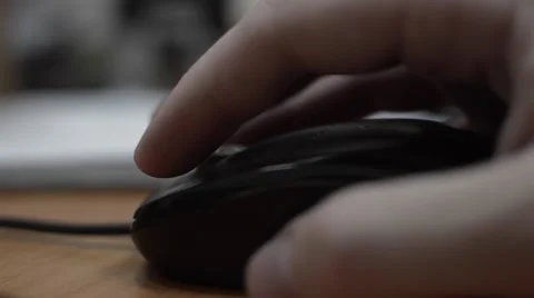 A person controls a computer mouse on the table Stock Footage 55837061