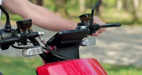A person controls a moped using a steer wheel Stockbeeldmateriaal 143259752