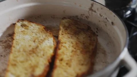 A person is cooking bread in a pan Stock Footage 305647792