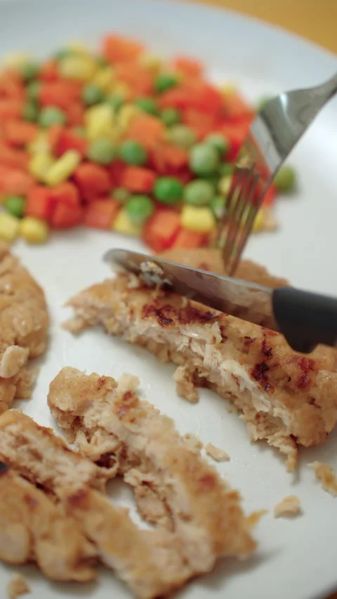 Person cooking a plant-based burger in a modern kitchen. Meat alternative. Stock Footage 338331368