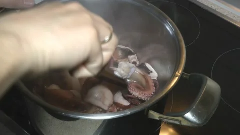 Person cooks an octopus in the kitchen. 스톡 동영상 238853537