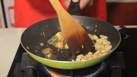 A person cooks processed meat. Sautes the meat in a frying pan. Stock Footage 334268779
