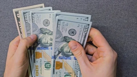 Person counting dollar banknotes in hands. Cash counting process Stock Footage 310844828
