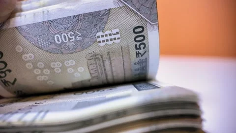Person counting a large stack of indian 500 rupee banknotes Stock Footage 339263482