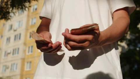 Person counting a small amount of paper money and showing disappointment. C.. Stock Footage 335652913