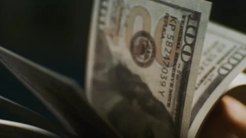 Person counting stack of hundred dollar bills with fingers in slow motion. Stock Footage 337411908