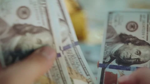 Person counting stack of hundred dollar bills close up view of financial tr.. Stock Footage 337601484
