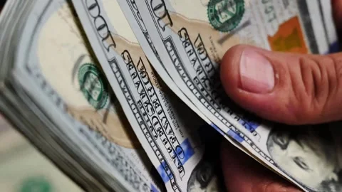 Person counting stack of hundred dollar bills, Hands holding currency cash money Stock Footage 339590851