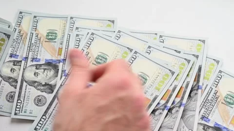 Person counting stack of hundred dollar bills on white background in close .. Stock Footage 339646211