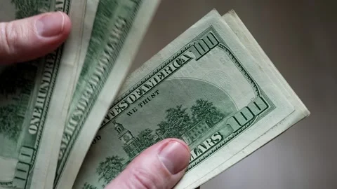 Person counting stack of one hundred dollar bills Stock Footage 295830719