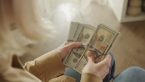 Person counting stack of US dollar bills Stock Footage 277150748