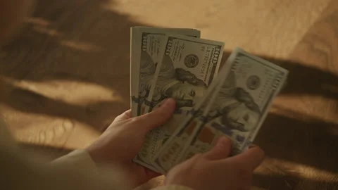 Person counting stack of US dollars Stock Footage 310778622