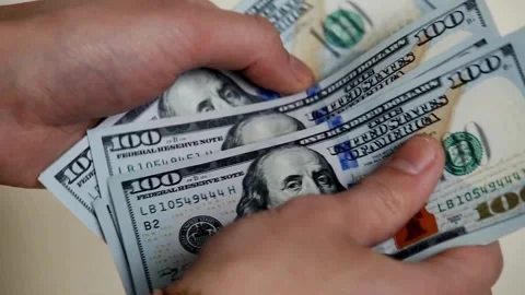 Person counts dollar banknotes in hands. Man counting American money by his.. Stock Footage 266469451