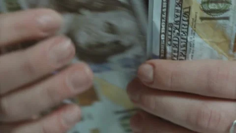 Person counts dollar banknotes in hands. Man counting American money by his Stock-Footage 336259651