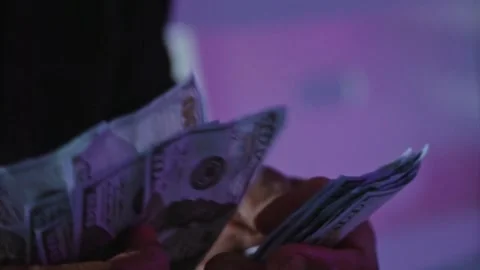 Person counts dollar banknotes in hands. Man counting American money by his Stock-Footage 336259748