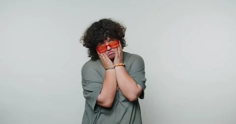 Person covers face with hands while holding fruit, showcasing mood of intro.. Stock Footage 316180814