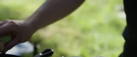 Person cracking eggs into the frying pan at campsite Stock Footage 69199658