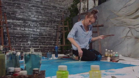 The person creates an art while sitting on the floor Stock-Footage 151070174