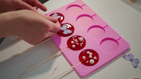 Person creates lollipops with decorative elements Stock Footage 336053668
