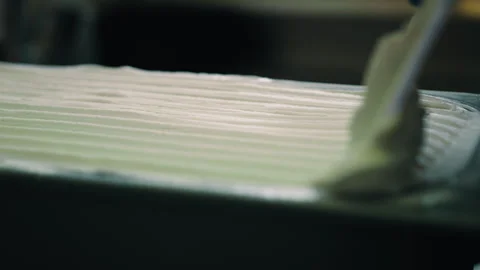 Person creates pattern in thick cream in baking mold Stock Footage 274601933