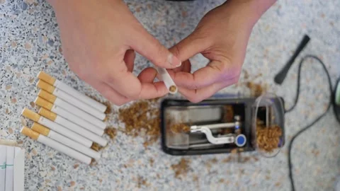 A person Creating Cigarettes at Your Own Residence with the Use of a Tobacco Stock Footage 304683605