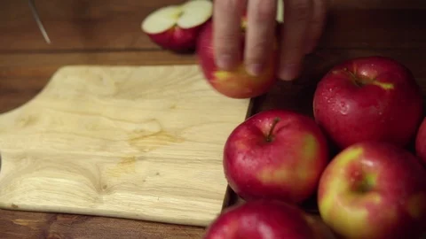 Person cuts an apple into slices on a cutting board. Stock Footage 102447100