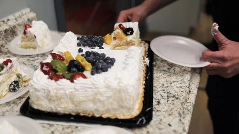 A person cuts a fruit cake Stock Footage 124767843