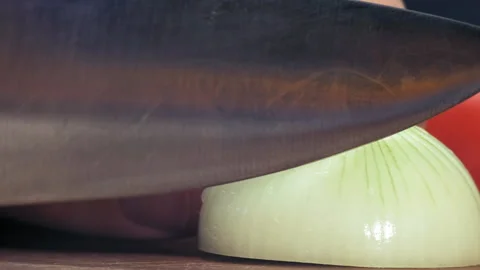 Person cuts onion with large sharp knife preparing salad Stockbeeldmateriaal 147061989