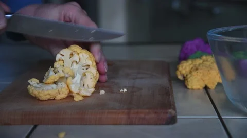 Person cuts yellow cauliflower Stock-Footage 219884635
