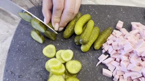 A person is cutting up a block of ham on a cutting board Vidéo 279299565