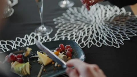 A person is cutting up fruit on a plate Stock Footage 295995677