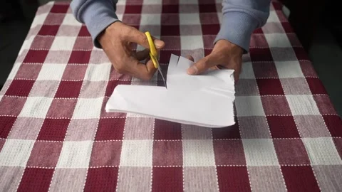 Person Cutting Paper with Scissors Stock Footage 339563920