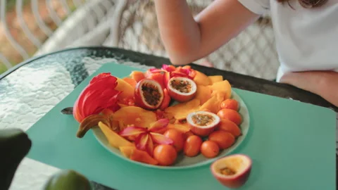 Person cutting up plate of fruit on table Stock Footage 270956892
