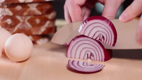 Person cutting slices of red onion. Video stock 146275953