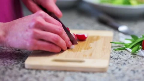 Person cutting tomatoes in the kitchen Stock Footage 170079252