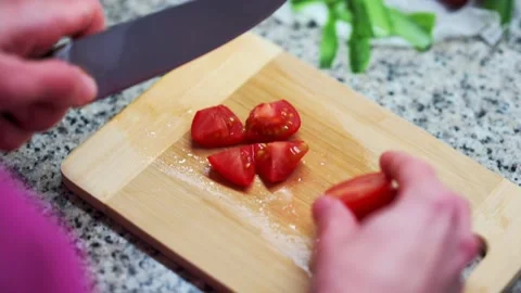 Person cutting tomatoes in the kitchen Stock-Footage 170079581