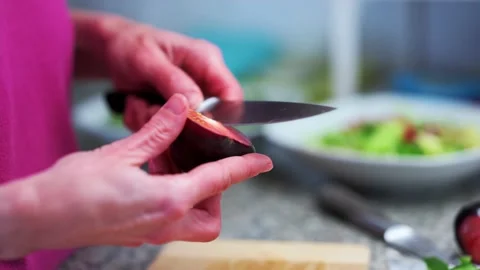 Person cutting vegetables (tomatoes) Stock Footage 200231371
