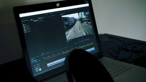 Person cutting video using premiere in dark room Stock Footage 81326343