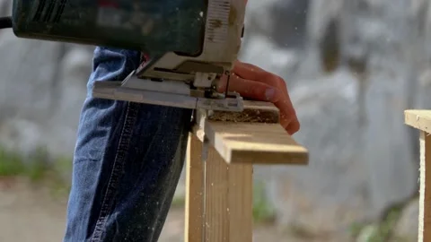 Person cutting wood panels using industrial tool to right shape for instalation Stock Footage 139743622