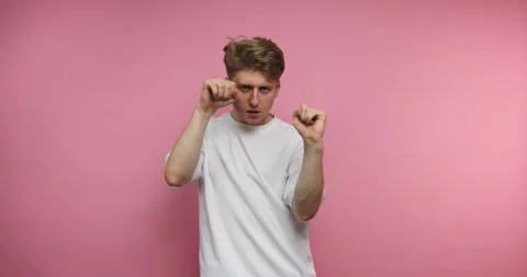 Person dances and expresses different feelings against a pink background at.. Stock-Footage 331990911