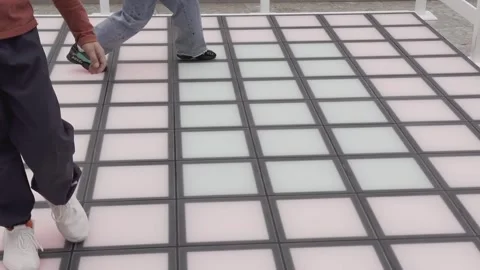 A person is dancing on a floor with a colorful pattern Stock Footage 279823441