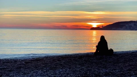 Person decided to take a break during a walk, put bag next to her and relax to Stock Footage 170036139