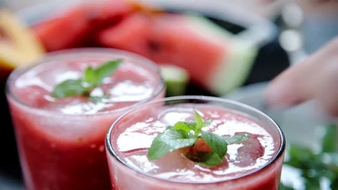 Person decorates red smoothie Stock Footage 79933108