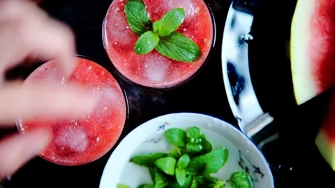Person decorates red smoothie Stock Footage 79933339