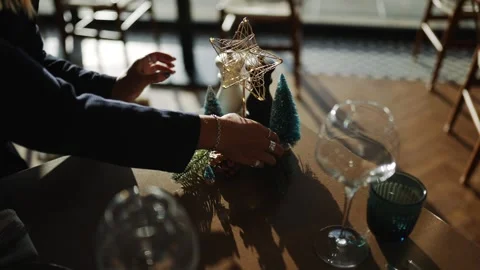 A person is decorating a table with a star and some trees Stock Footage 295993733