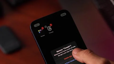 A person deleting Threads App from their phone Stock Footage 247559125