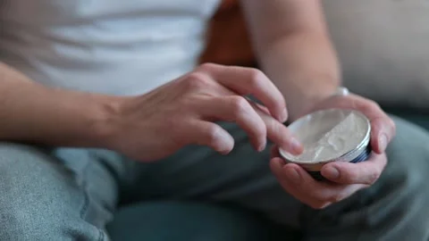 A person demonstrates applying moisturizer to hands in a step-by-step process at Stock-Footage 337111431