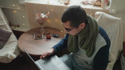 Person at desk adjusting screen with decorative background. Male working on Stock Footage 333326075